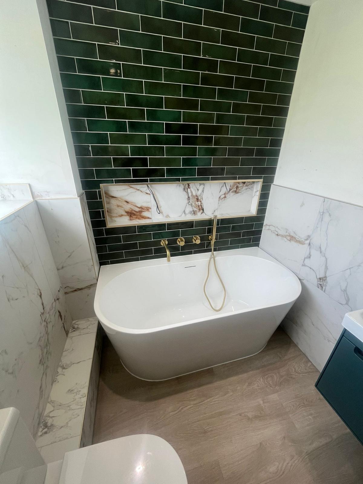 Bathroom project in Timperley with freestanding bath, green feature tiles and brushed brass fittings